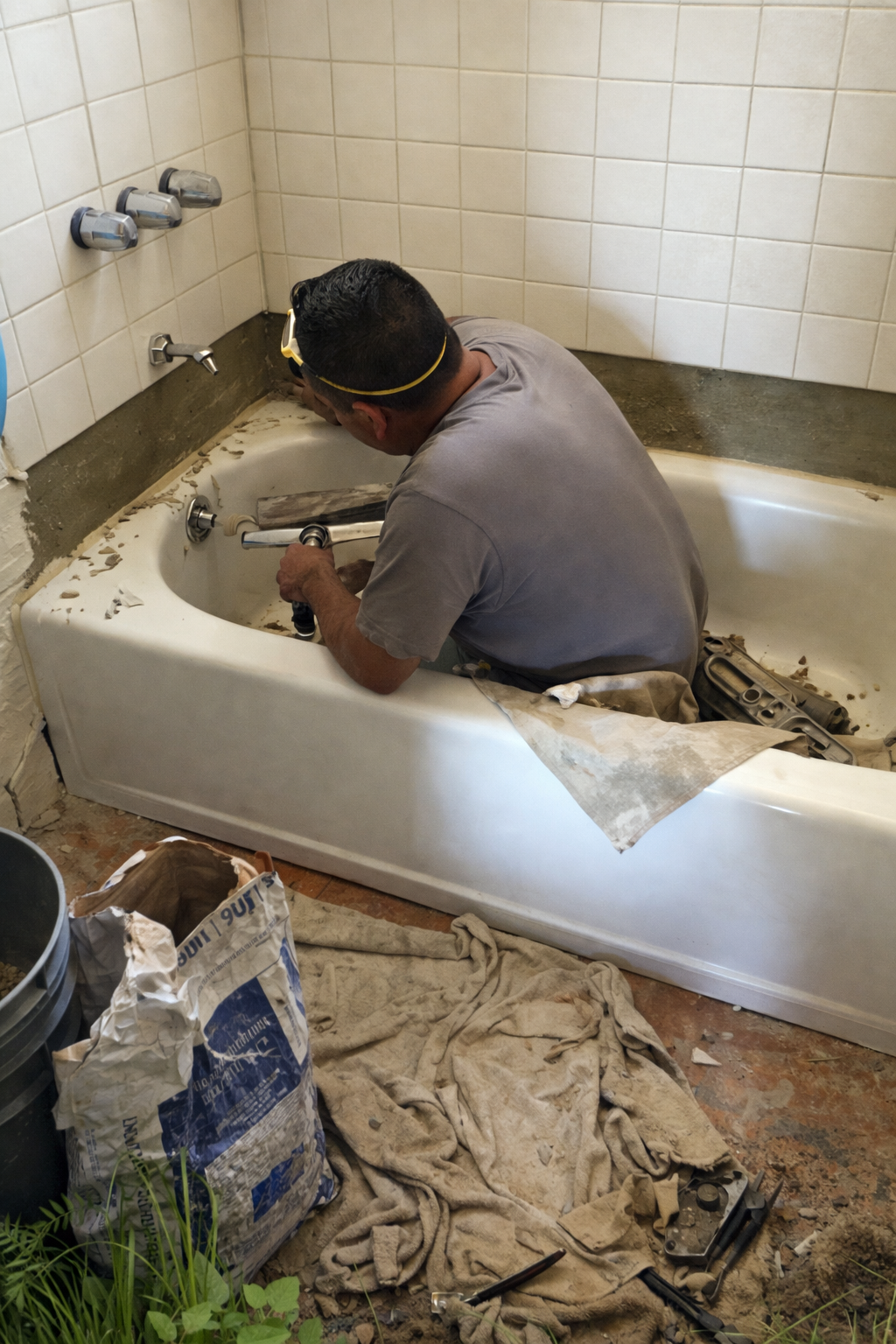 Bathtub plumbing repair in progress